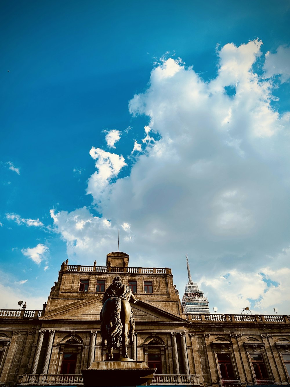 a large building with a statue in front of it