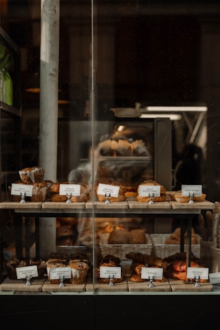 A warm bakery storefront with fresh breads and pastries displayed invitingly.
