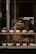 A vibrant display of assorted baked goods, including croissants and muffins, on a bakery shelf.