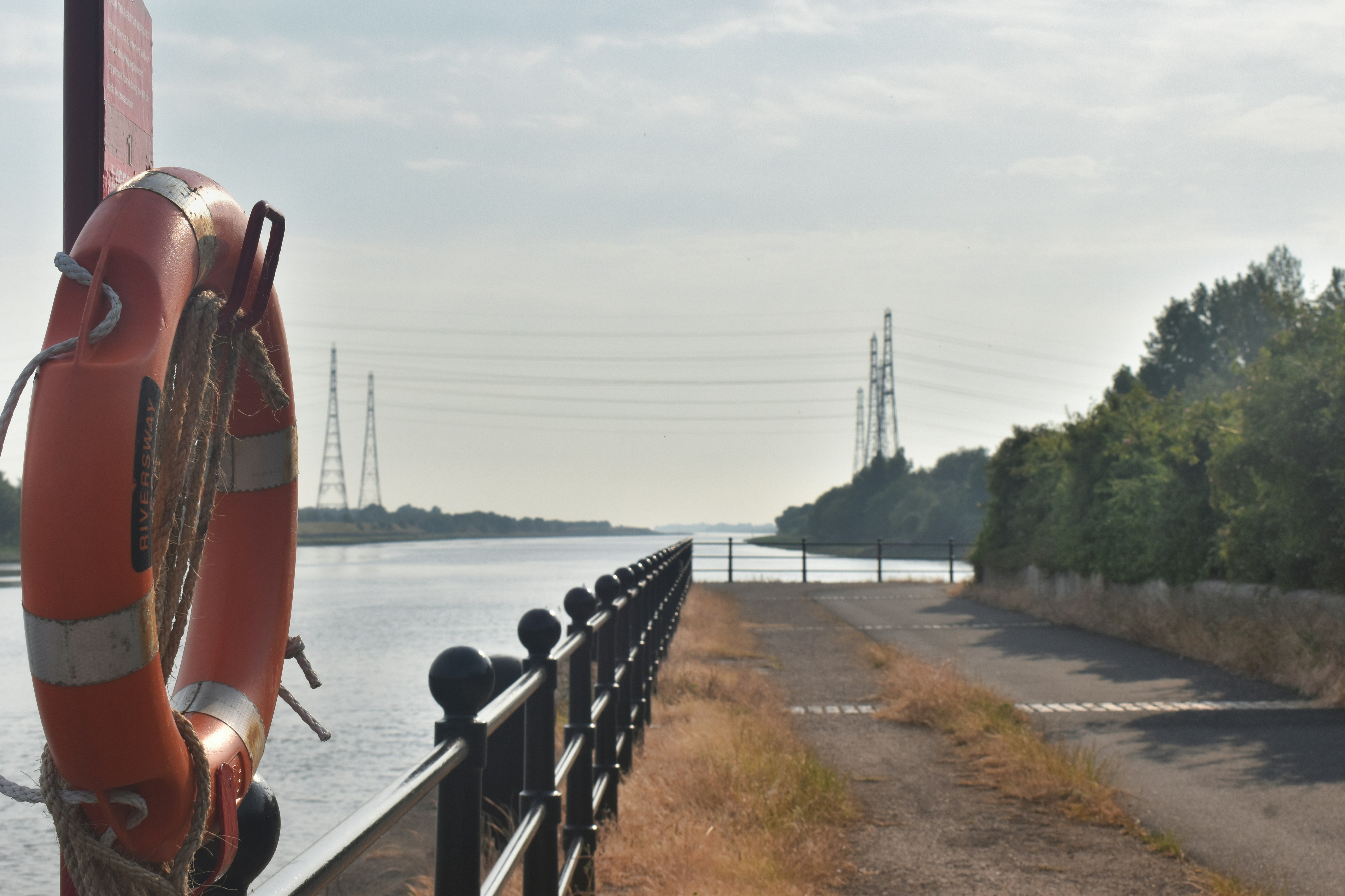an orange life preserver sitting on the side of a road