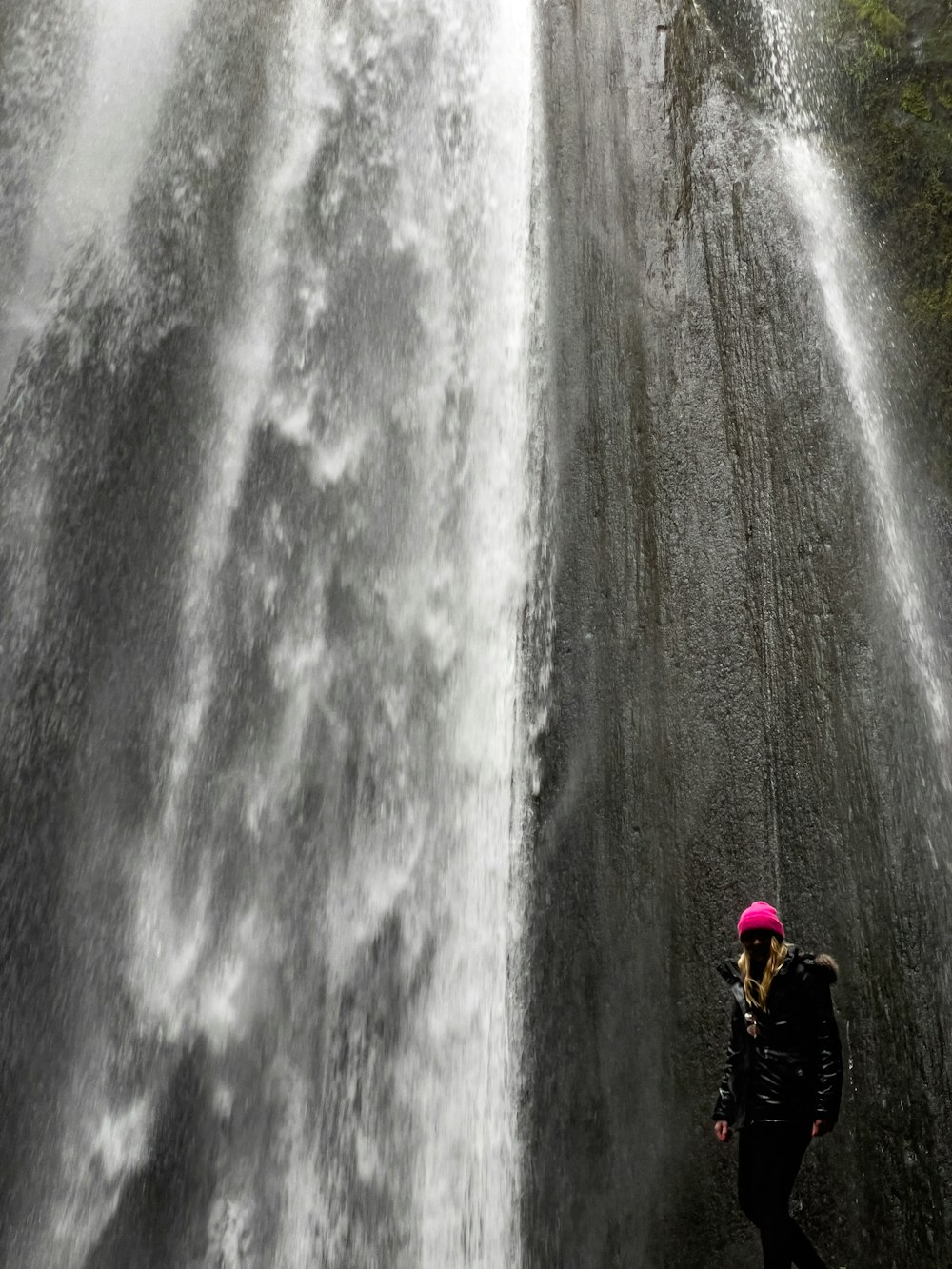 a person standing in front of a waterfall