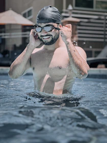 A man in a van smiling while checking chemical levels on a digital log using Poolmate.