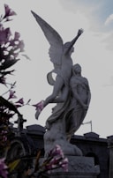 Marble statue of a playful child reaching upwards, symbolizing hope and new beginnings.