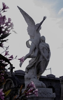 Marble statue of a playful child reaching upwards, symbolizing hope and new beginnings.