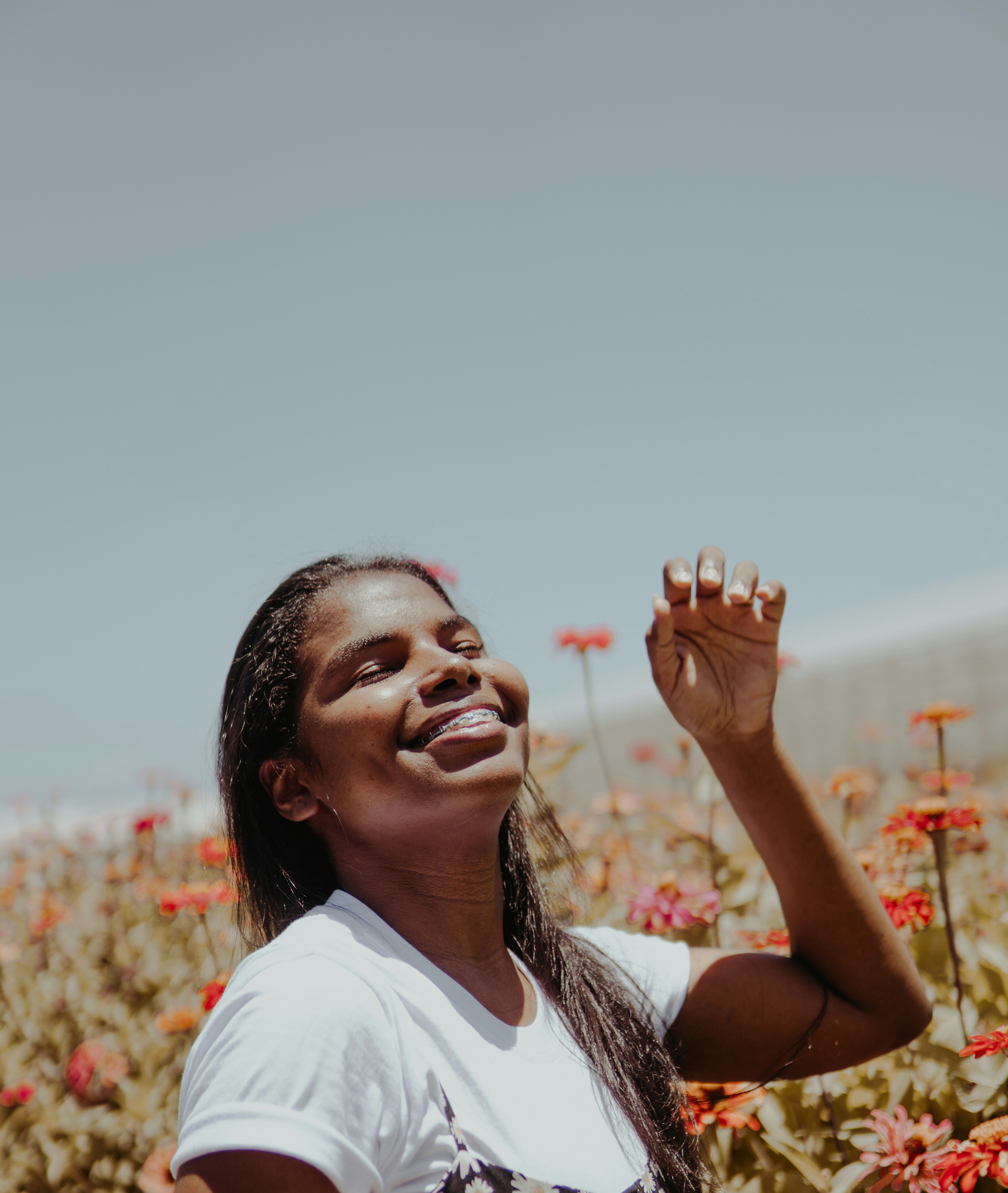 a woman standing in a field of flowers