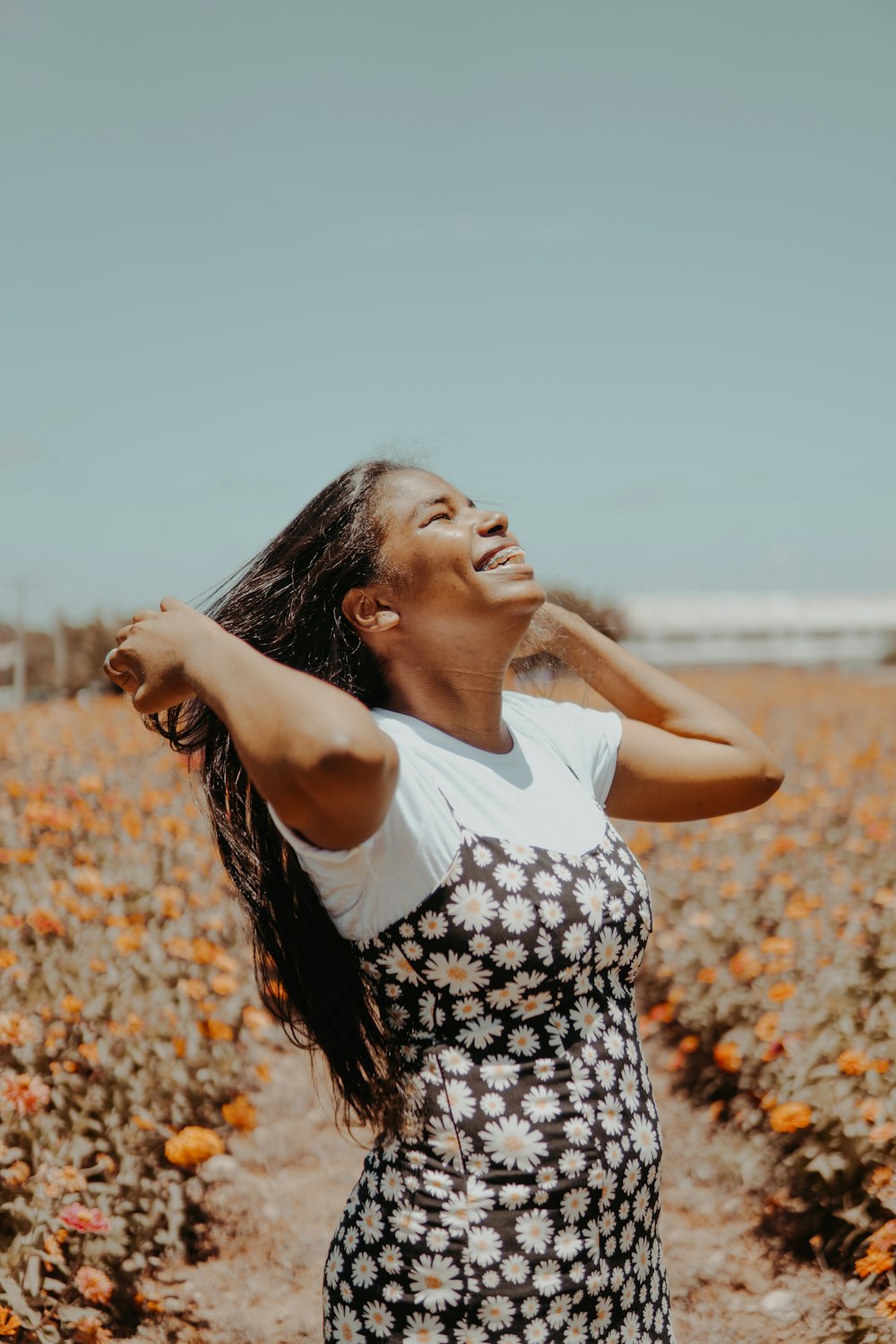 a woman standing in a field of flowers