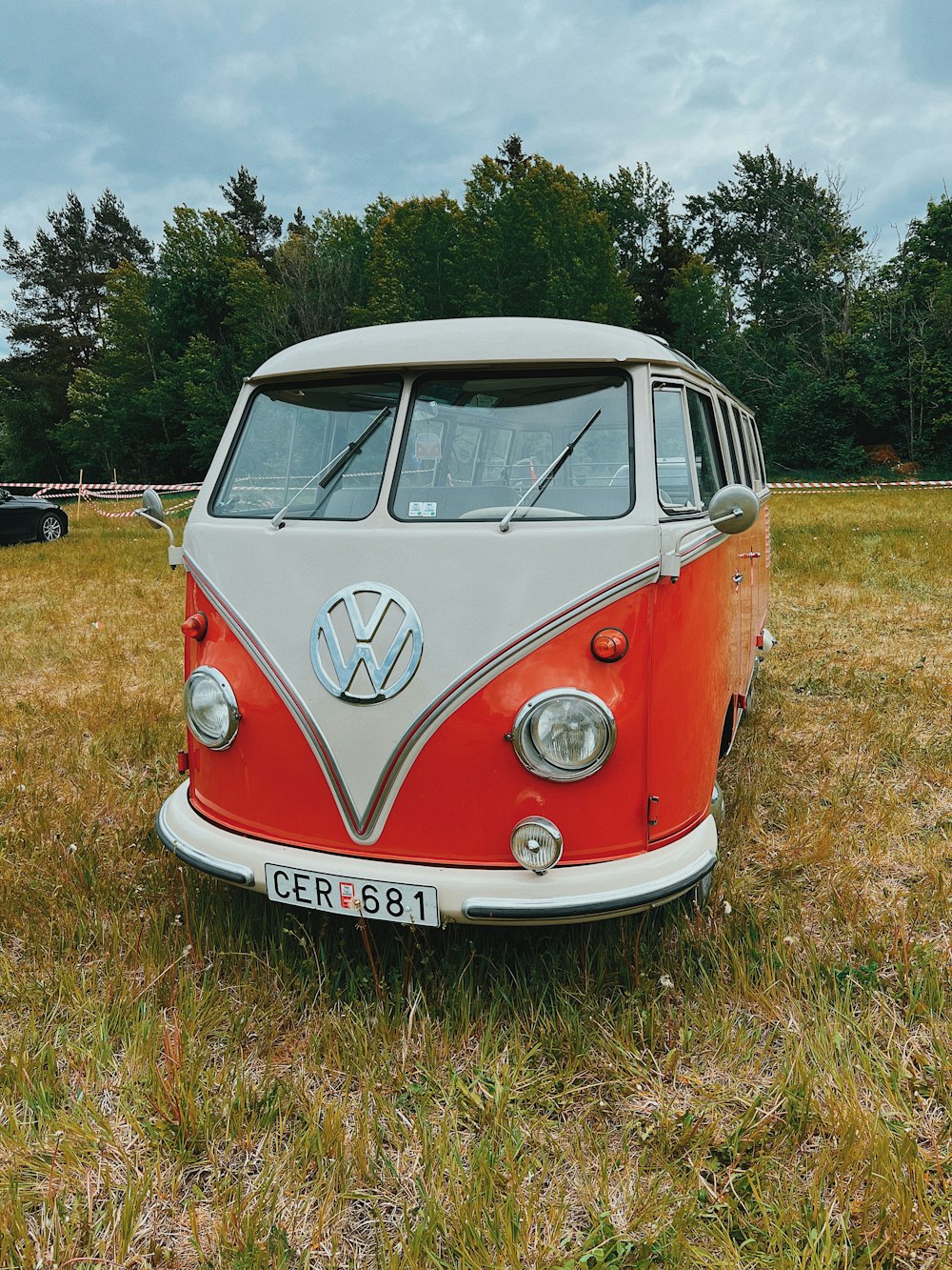 an old vw bus is parked in a field