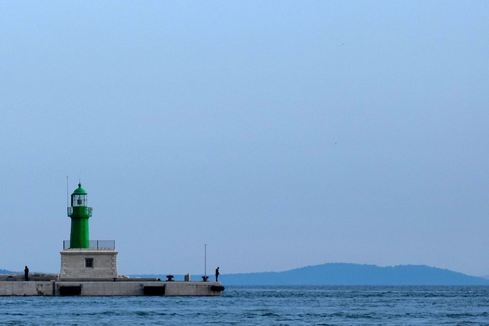 a light house in the middle of a body of water