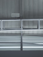 Metallic beams and supports form a structured pattern against a ribbed industrial ceiling. Several rectangular vents or panels are visible, adding to the utilitarian design.