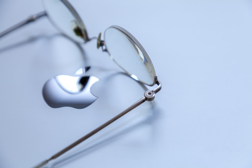 a pair of glasses sitting on top of a table