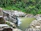 Serene natural pool surrounded by lush greenery at the pousada Vermelho Éden.
