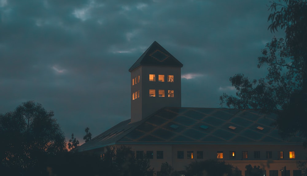 a building with a clock tower lit up at night