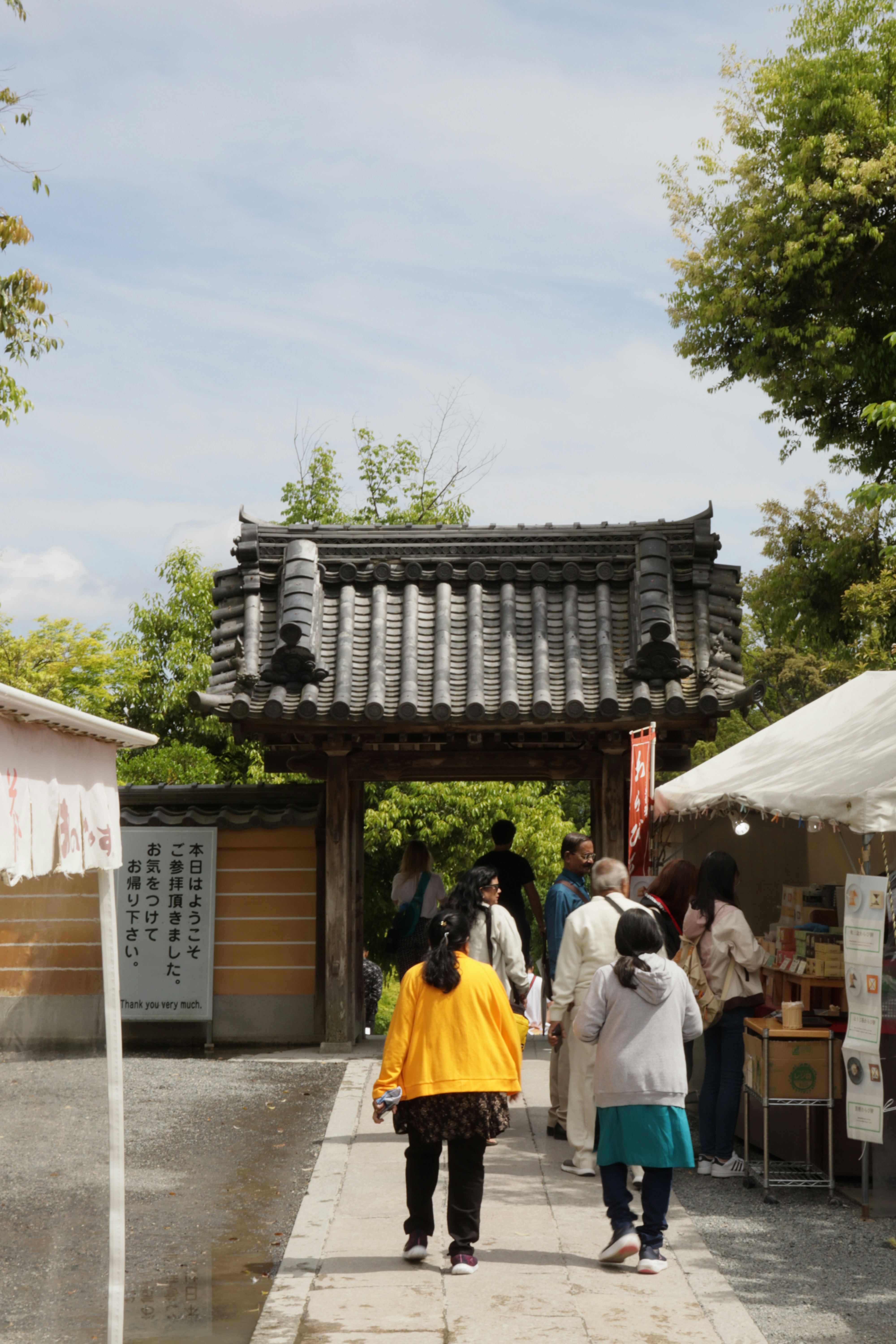 a group of people walking down a sidewalk