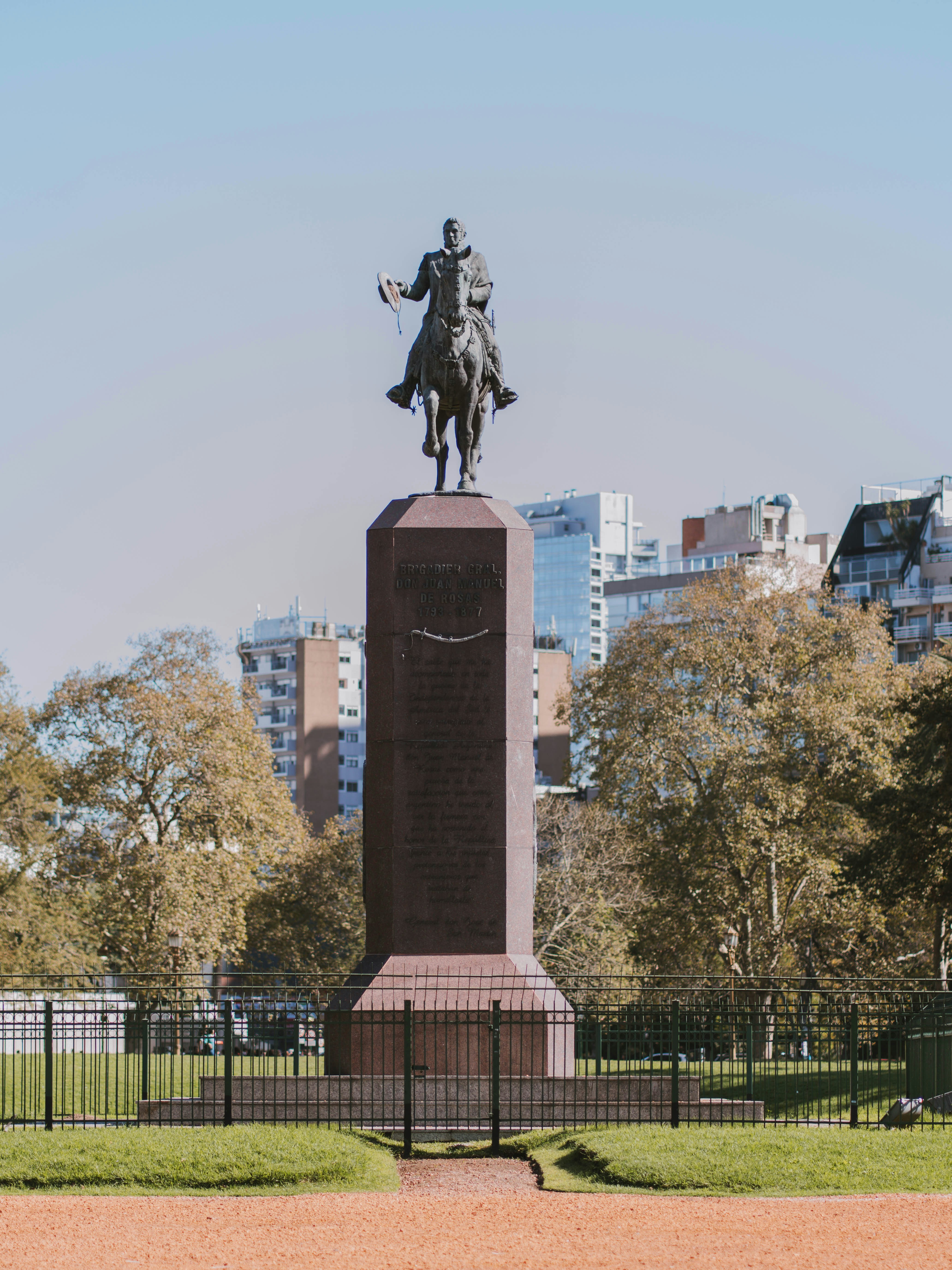 a statue of a man on a horse in a park