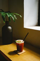Matte forest green pen bark texture beside a Scandinavian-style dish on a cozy wooden table.
