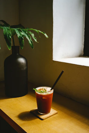 Matte forest green pen bark texture beside a Scandinavian-style dish on a cozy wooden table.