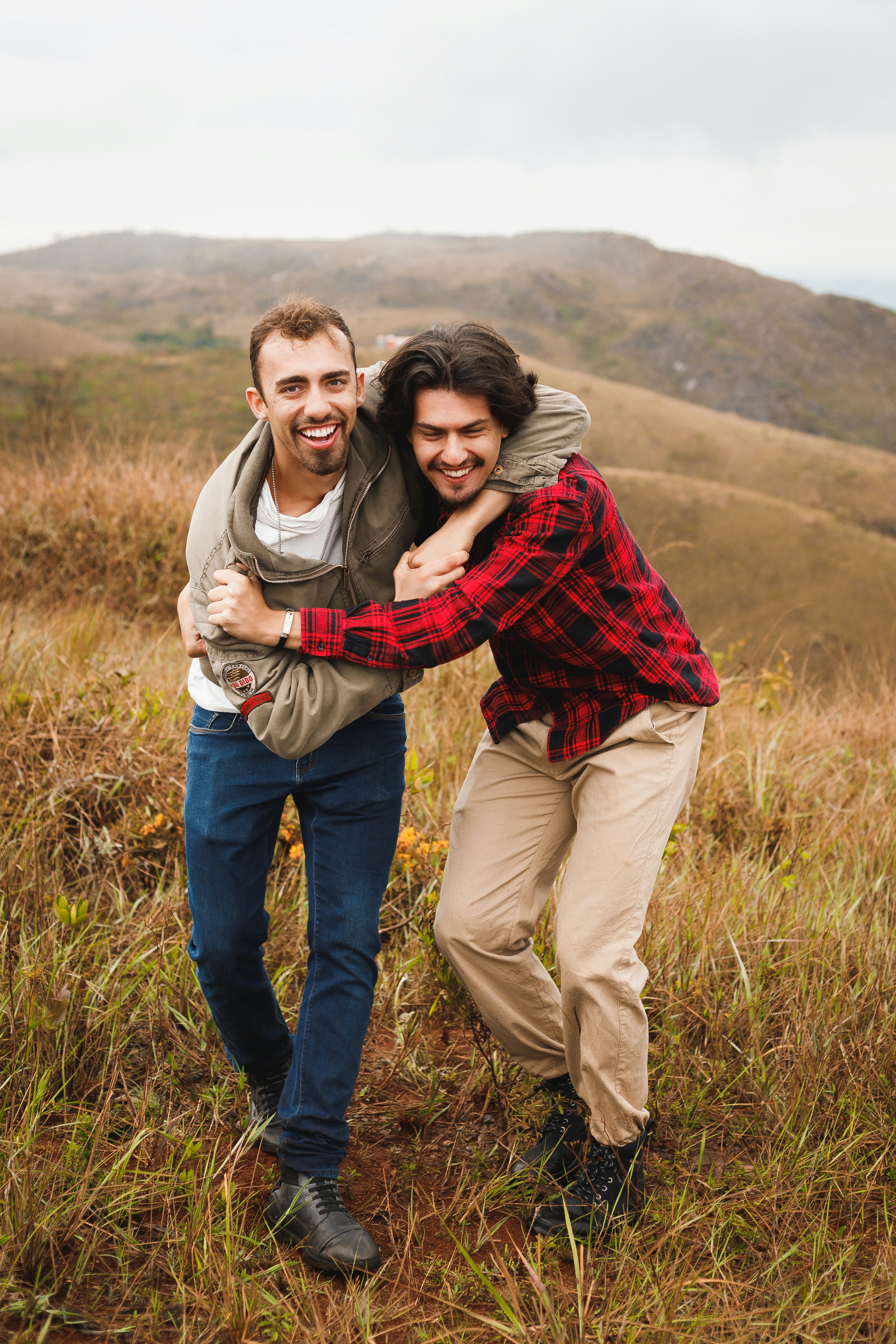 a couple of men standing next to each other in a field