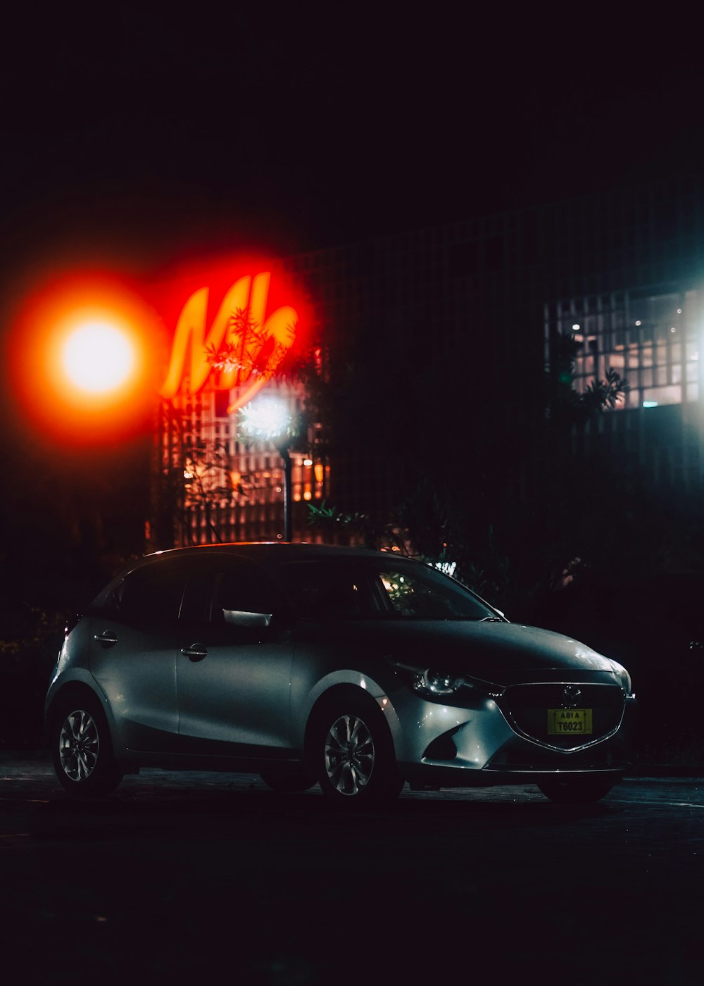 a car parked on the side of the road at night