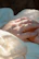 Close-up of a man gently cleaning a silver ring with a soft cloth.