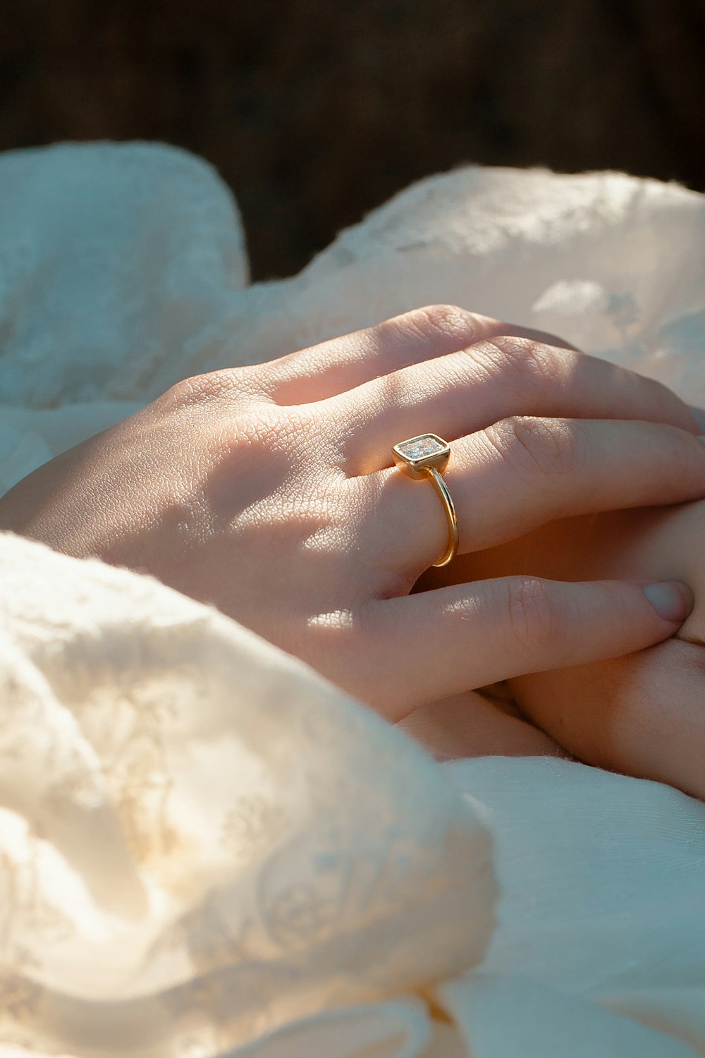 a close up of a person's hand with a ring on it