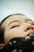 A close-up of a tranquil face in deep relaxation.