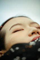 Close-up of peaceful eyes closed softly, suggesting inner calm and healing.
