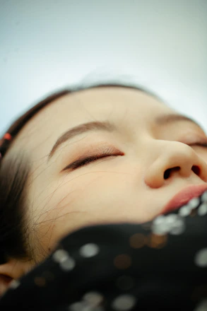 Close-up of a serene woman’s eyes showing natural, refreshed eyelids after hybrid blepharoplasty.