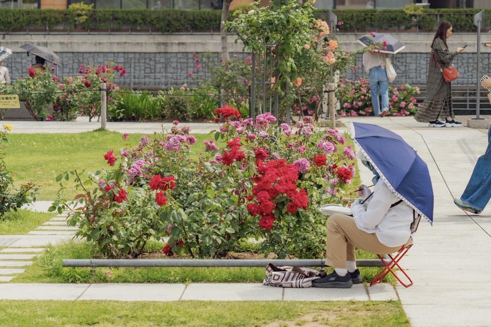 a person sitting on a bench with an umbrella