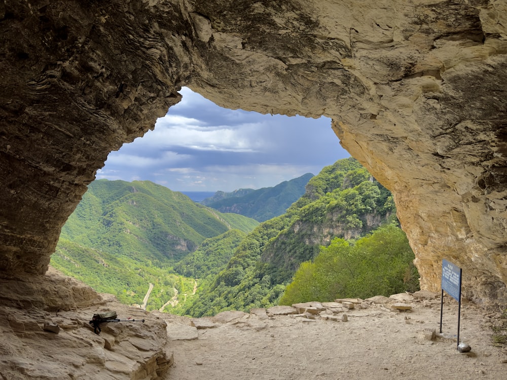 a view of a valley through a cave