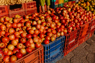 Close-up of fresh red apples in a wooden crate at a local market