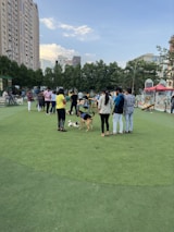 A group of pet care providers discussing services in a sunny park setting.
