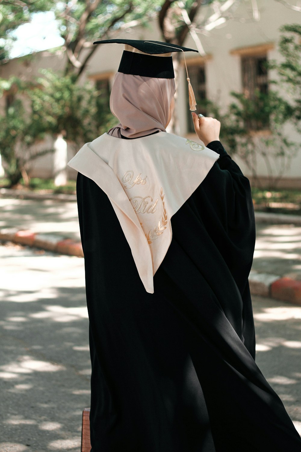 a woman in a graduation gown and cap