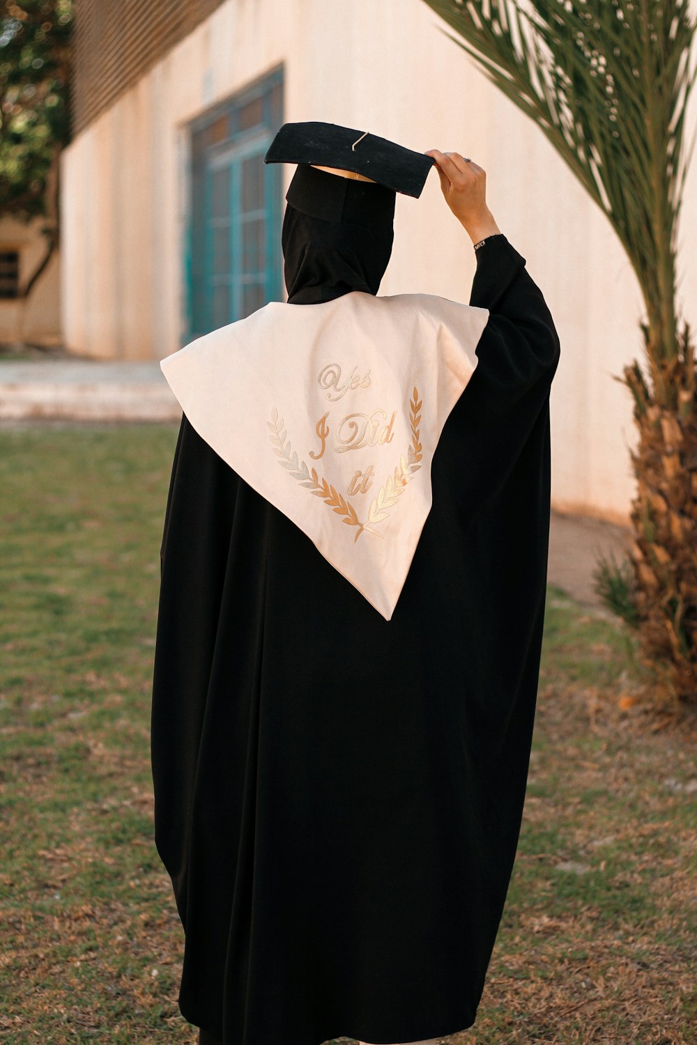 a person wearing a graduation gown and a hat