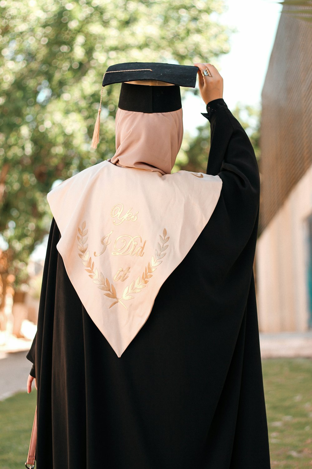 a person wearing a graduation gown and a hat