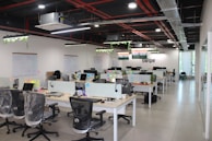 A sleek office interior featuring modern desks and technology equipment.