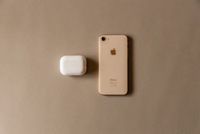 Minimalist display of phone accessories including cases, chargers, and headphones on white background