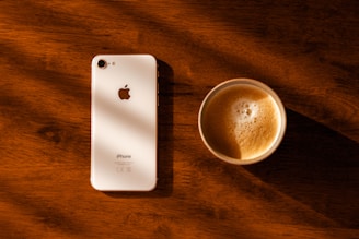 Classic iPhone 14 Pro Max resting on a wooden table with natural light.