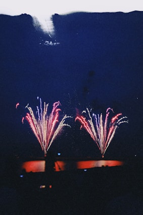 A vibrant South Dakota landscape with fireworks lighting up the night sky, evoking celebration and community pride.