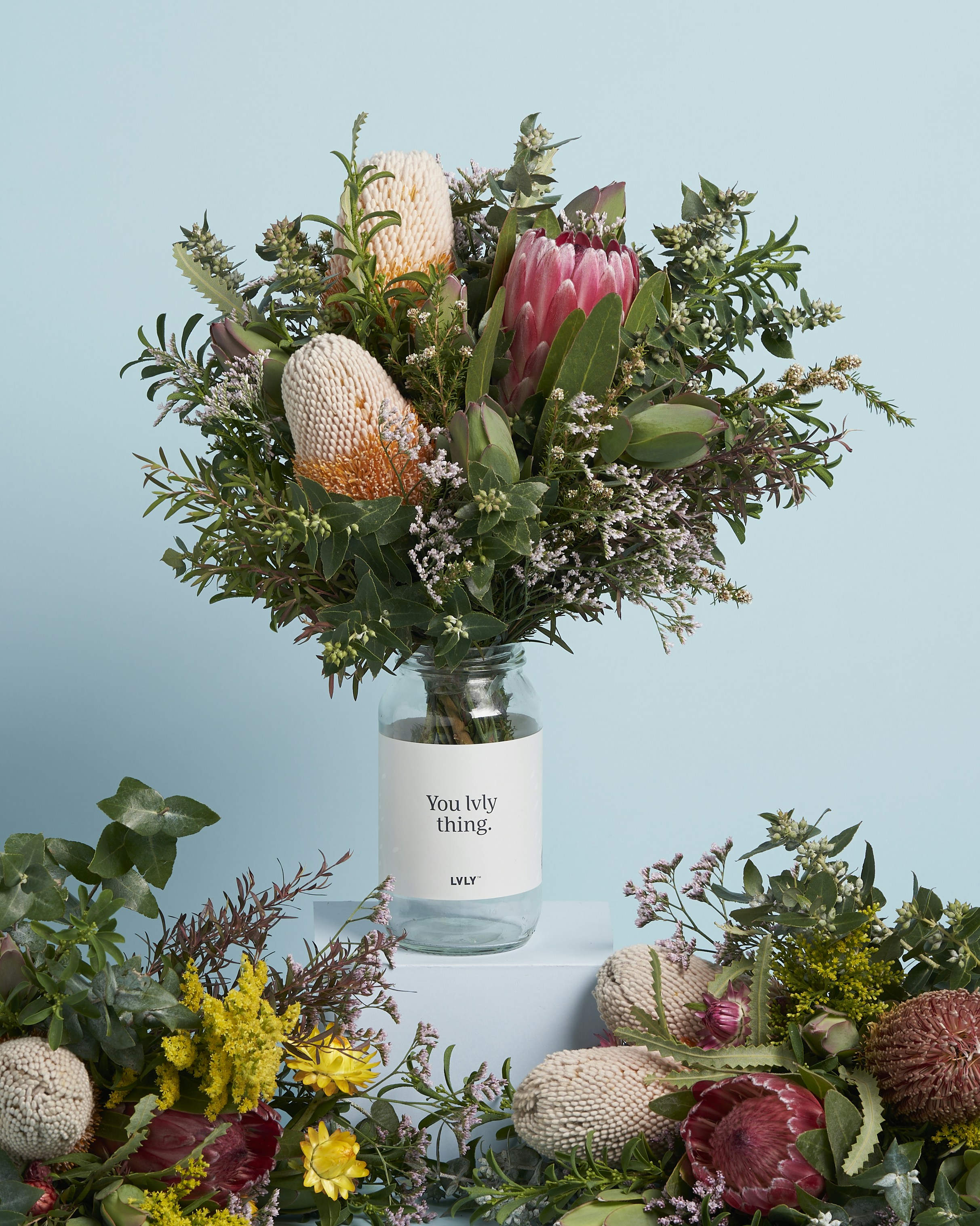 a vase filled with lots of flowers on top of a table
