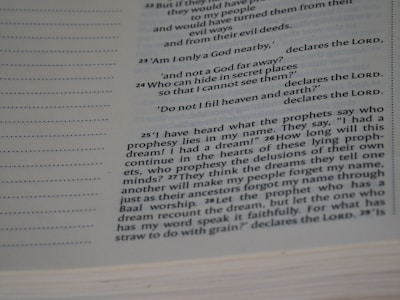 A close-up view of a book page featuring a passage in English. The text includes biblical references, with some parts in bold and the word 'LORD' prominently displayed multiple times. The layout includes line numbers on the left and the text is formatted in a serif font.