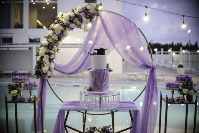 Elegant outdoor wedding setup at a luxurious Marbella finca with vibrant floral decorations and royal purple accents.