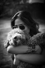 a woman holding a dog in her arms