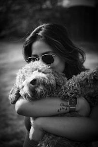 a woman holding a dog in her arms