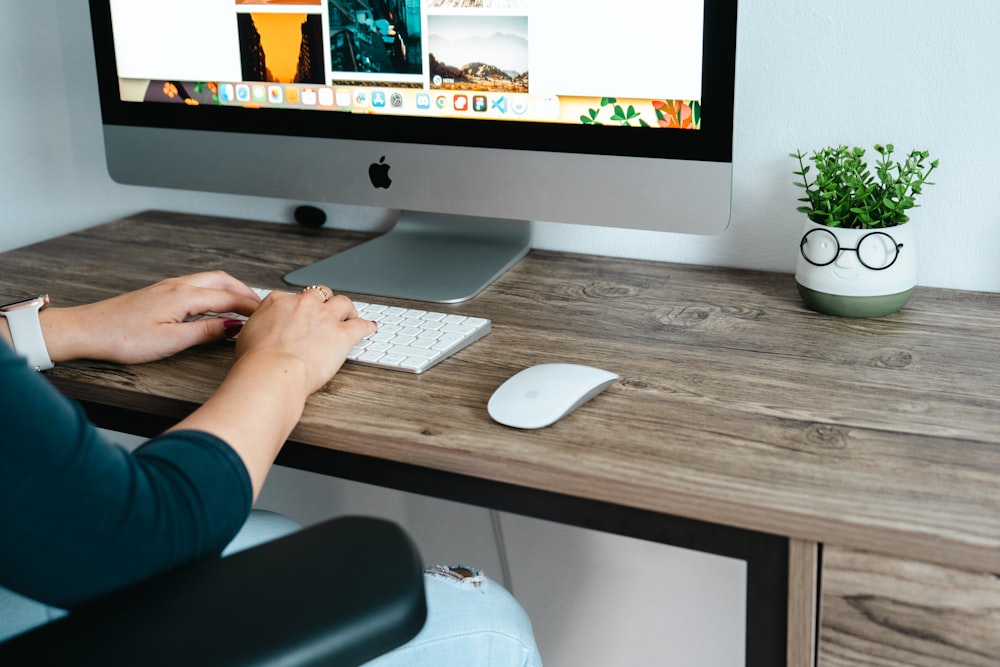 a person sitting at a desk with a computer