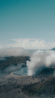 Close-up of Bromo’s smoking crater with blue sky background