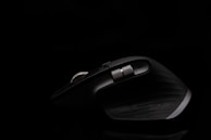 A sleek ergonomic mouse resting on a soft wrist support pad.