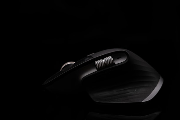 A sleek ergonomic mouse resting on a cobalt-blue gradient surface, highlighting smooth curves and comfort.