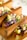 Tacos filled with vibrant ingredients like purple cabbage, avocado, radish slices, feta cheese, sesame seeds, and fresh dill, served in wooden taco holders.