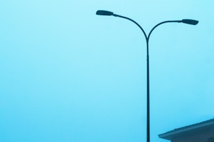 a street light with a building in the background