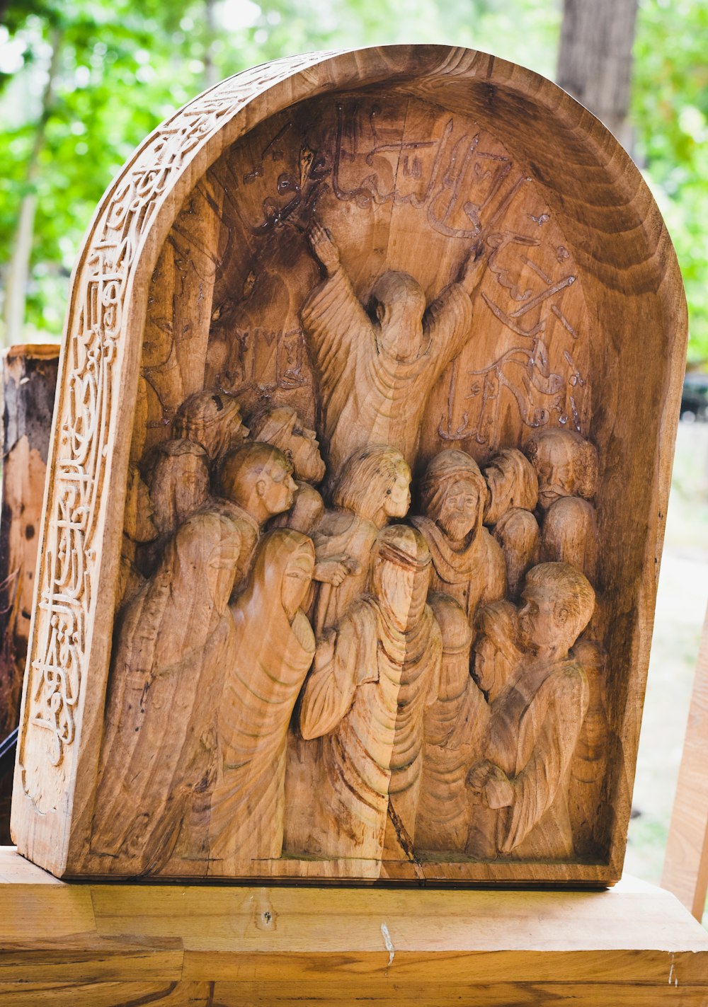 a wooden carving of a group of people